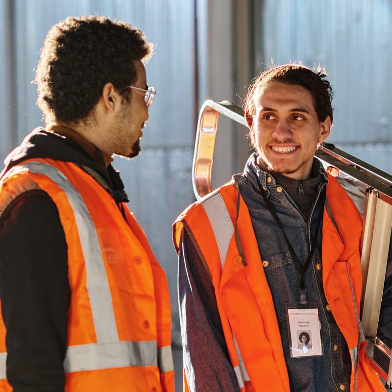 Two tradies talking on a worksite